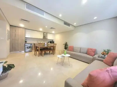 a living room with a couch and a table at Mangroovy- 1BR Sparkling Condo in Hurghada