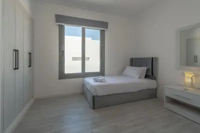 a white bedroom with a bed and a window at Luxury Villa with private pool Sholan 2 in Hurghada