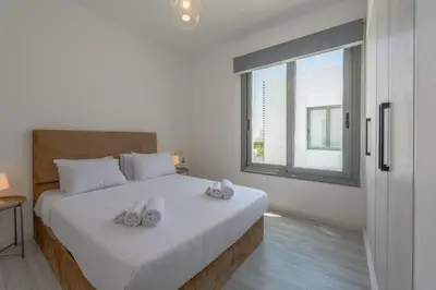 a bedroom with a large white bed with slippers on it at Luxury Villa with private pool Sholan 2 in Hurghada