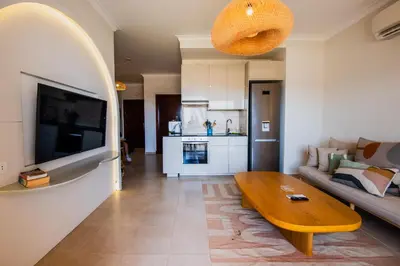 a living room with a couch and a wooden coffee table at Luxury One Bedroom Apartment with Sea view in SomaBay in Hurghada