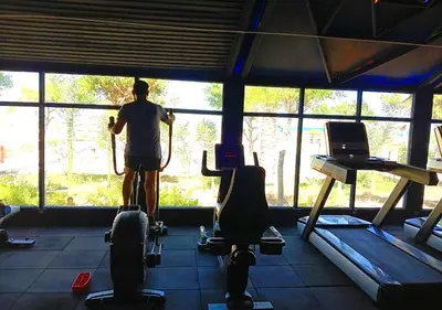 a man standing in a gym looking out the window at Davinci Beach Resort in Hurghada