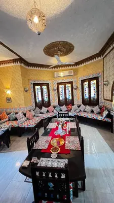 a large room with long tables and chairs in it at Villa Barba Luxor in Luxor