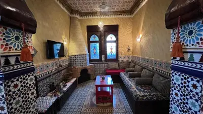 a living room with a couch and a tv at Villa Barba Luxor in Luxor