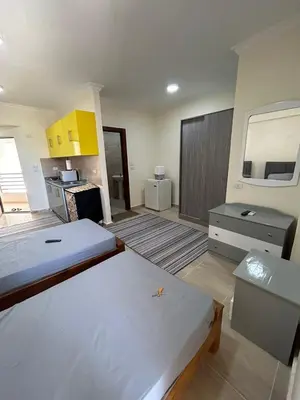a room with two beds and a kitchen at Princess resort 307 in Hurghada