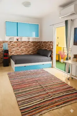 a bedroom with a bed and a brick wall at Wavesong Whispers flat where you can enjoy seaview with the best price and enjoy speedy wifi in Hurghada