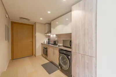 a kitchen with a washer and dryer in it at Stylish Gouna Escape 2BR Mangroovy Beach Pool Access in Hurghada