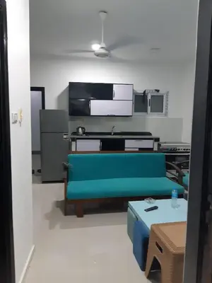 a living room with a blue couch and a table at الغردقة الدهار القيادات in Hurghada