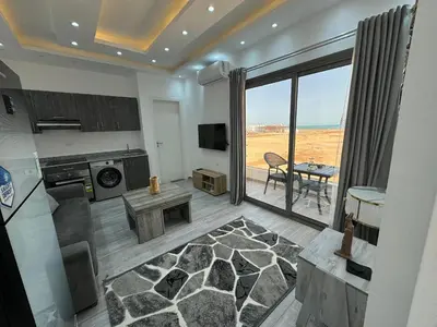 a living room with a view of the ocean at Imperial resort in Hurghada
