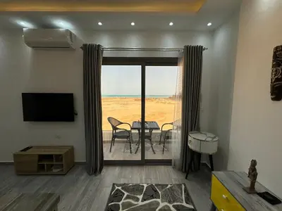 a living room with a sliding glass door with a view at Imperial resort in Hurghada