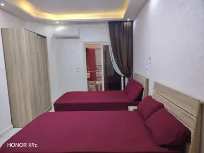 a bedroom with two beds with purple sheets at Casablanca Beach hurgada كازابلانكا بيتش الغردقه in Hurghada