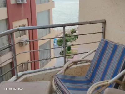 a chair on the balcony of a building at Casablanca Beach hurgada كازابلانكا بيتش الغردقه in Hurghada