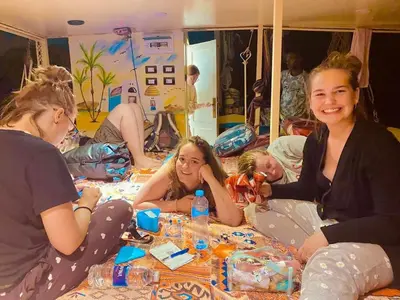 a group of girls sitting around a table at Felucca sailing boat from Aswan to komombo with private bathroom in Aswan