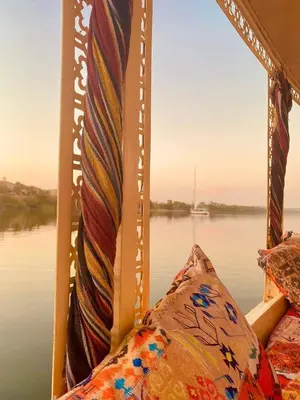 a window on a boat looking out over the water at Felucca sailing boat from Aswan to komombo with private bathroom in Aswan