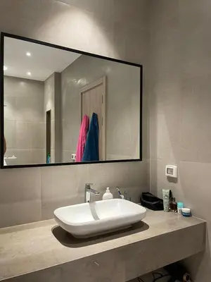 a bathroom with a sink and a large mirror at ElGouna, Elegant 1Bedroom, private patio in Fanadir Marina in Hurghada