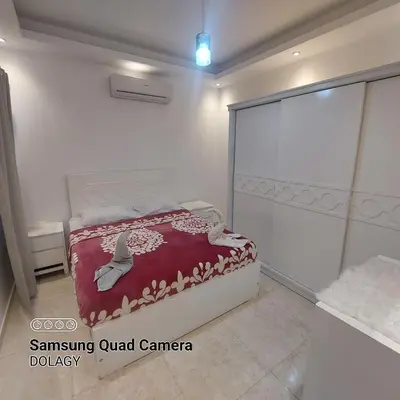 a bedroom with a bed with a red blanket at Selena bay resort in Hurghada