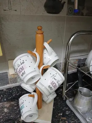 a pile of coffee cups sitting on a kitchen counter at Hossam Cozy Apartment El Hadaba Sheraton in Hurghada