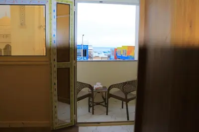 a room with a table and two chairs and a window at Hossam Apartment Marina Area Hurghada in Hurghada