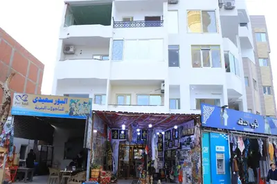 a building with a store in front of it at Hossam Apartment Marina Area Hurghada in Hurghada