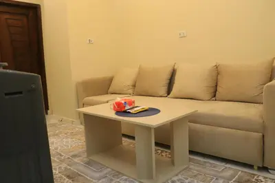 a living room with a couch and a table at Hossam Apartment Marina Area Hurghada in Hurghada