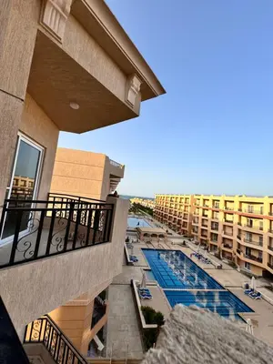 a view of the pool from the balcony of a hotel at Tolles Modernes Studio in Selena Bay in Hurghada