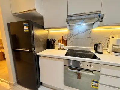 a kitchen with a stove and a refrigerator at Tolles Modernes Studio in Selena Bay in Hurghada