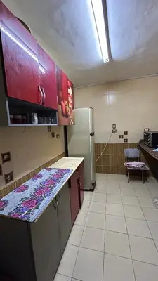 a kitchen with a counter top and a refrigerator at Super Elite apartment Nile View F6 in Naj‘ al ‘Amrāb