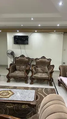 a living room with two couches and a tv at Super Elite apartment Nile View F6 in Naj‘ al ‘Amrāb