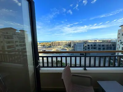 a balcony with chairs and a view of a city at Aldau Sunset in Hurghada