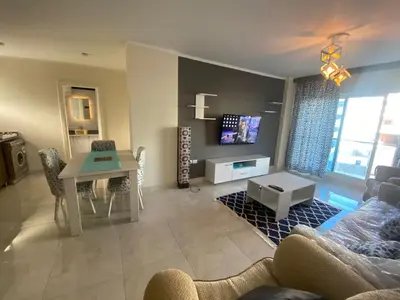a living room with a couch and a table at Red sea-Cozy one bedroom with sea view in Hurghada