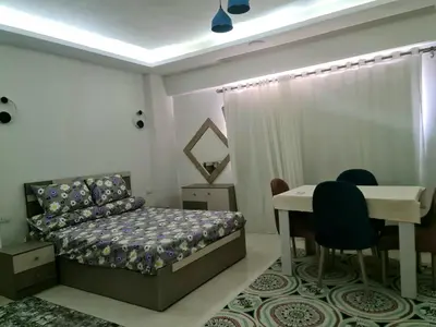 a bedroom with a bed and a table and chairs at Selena bay apartment beach in Hurghada