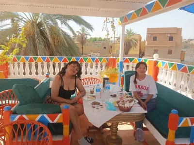 two women sitting at a table on a balcony at La Veranda \u967d\u53f0 in Aswan