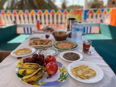 a table with plates of food and fruit on it at La Veranda \u967d\u53f0 in Aswan