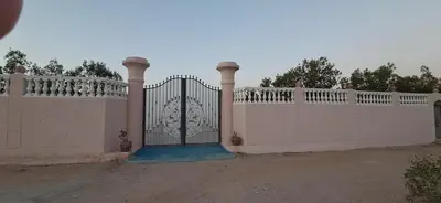 a white fence with a gate in front of it at ATON PALACE Luxor in Luxor