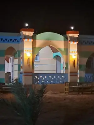 a building at night with lights on it at ATON PALACE Luxor in Luxor