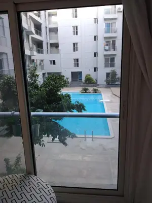 a view of a swimming pool from a window at Hurghada Stylish stay in Hurghada