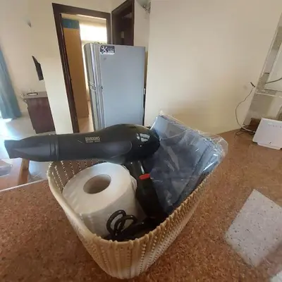 a hair dryer in a basket on a counter at Mamsha view 1 bedroom flat beside Russian consulate in Hurghada