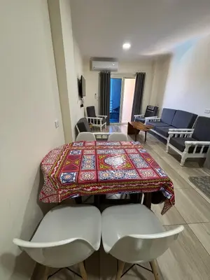 a room with a table and chairs and a living room at Sea View Beach Access Princess Resort Hurghada in Hurghada