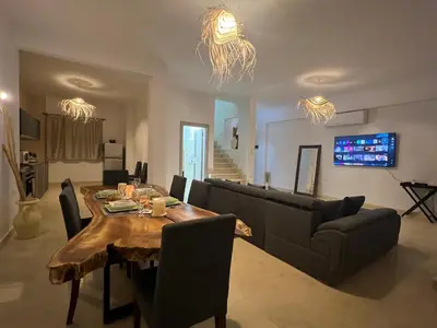 a living room with a table and a couch at Villa du bonheur 202 in Hurghada