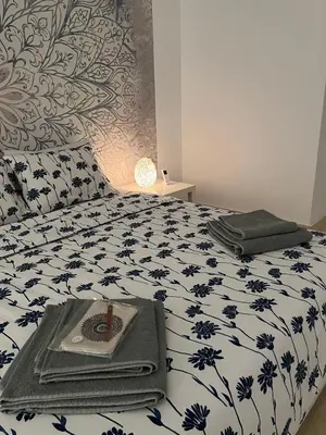 a bedroom with a bed with a black and white comforter at Villa du bonheur 202 in Hurghada