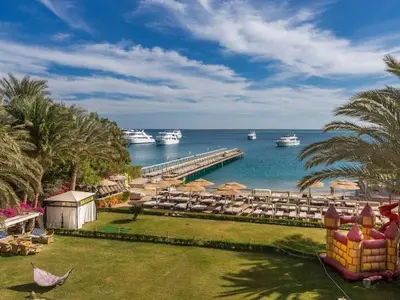 a resort with a pier and boats in the water at Salvatore Rooms- All Inclusive in Hurghada