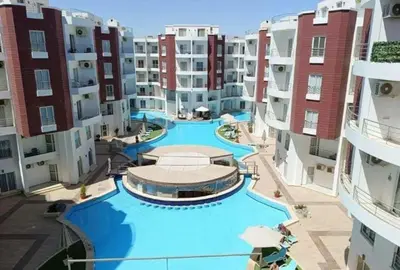 an aerial view of a swimming pool in a apartment building at Hotel Room in Aqua Palms Hurghada in Hurghada