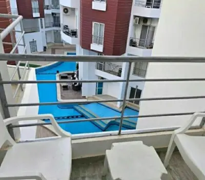 a view from the balcony of a building with two chairs at Hotel Room in Aqua Palms Hurghada in Hurghada