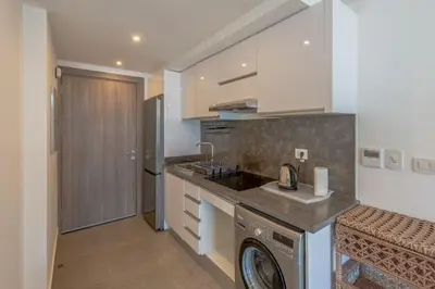 a kitchen with a washing machine and a washer at New & Chic 2BR with Pool Access Sholan 2 El Gouna in Hurghada