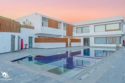 a house with a swimming pool in front of it at New & Chic 2BR with Pool Access Sholan 2 El Gouna in Hurghada