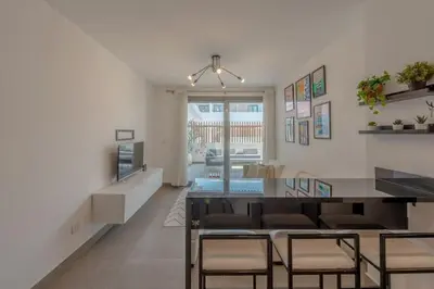 a living room with a table and some chairs at New & Chic 2BR with Pool Access Sholan 2 El Gouna in Hurghada