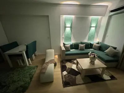 a living room with a green couch and a table at Luxurious heart flat in Hurghada