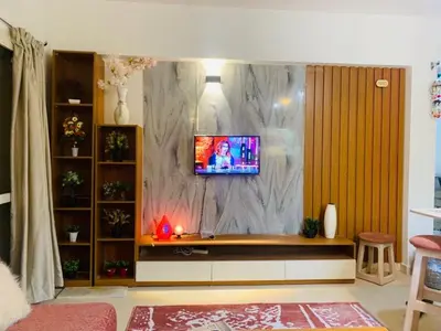 a living room with a tv on a marble wall at Makadi Heights lovely flat in Hurghada