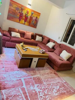a living room with a couch and a table at Makadi Heights lovely flat in Hurghada