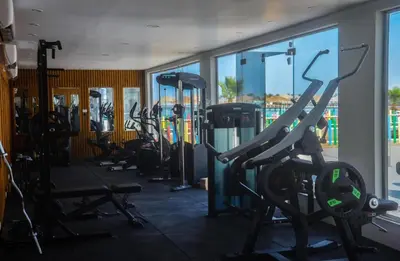 a gym with a row of treadmills and machines at Scanddic Resort Hurghada in Hurghada