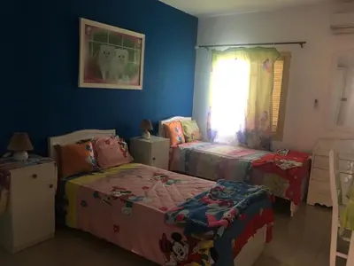 a bedroom with two twin beds and a window at Villa Sara Touristic Center in Hurghada